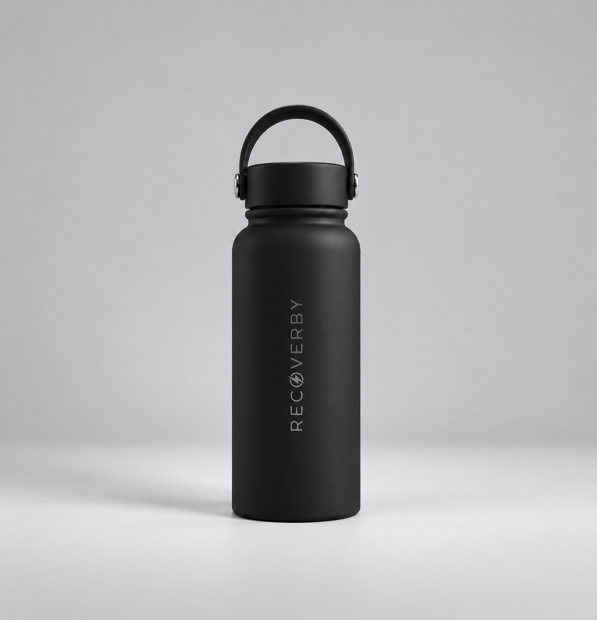A matte black insulated water bottle with a matching black loop handle lid, standing upright on a light gray studio background. The bottle features the brand name 'RECOVERBY' printed vertically in white near the lower half.
