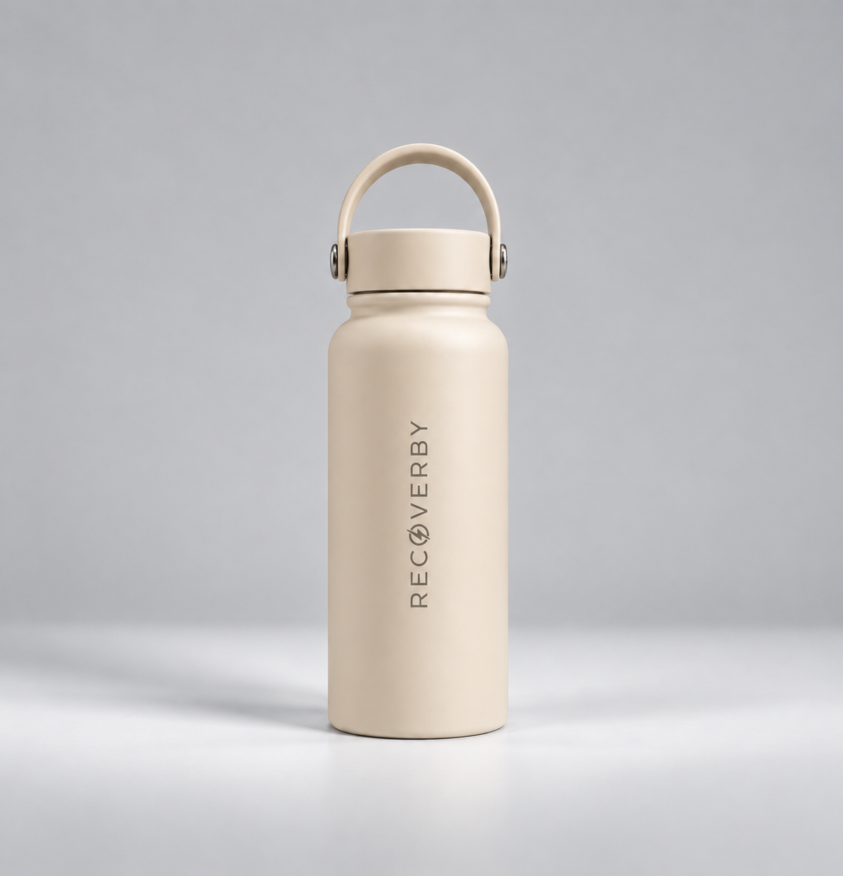 A matte beige insulated water bottle with a matching carry loop lid, standing upright on a light gray background. The brand name 'RECOVERBY' is printed vertically in black on the front.